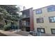 Inviting condo exterior featuring balconies, neutral siding, and well-maintained landscaping at 10890 W Evans Ave # 2E, Lakewood, CO 80227