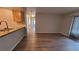 Spacious living area with sleek wood floors flowing into an open kitchen design at 10890 W Evans Ave # 2E, Lakewood, CO 80227