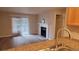 Bright living room featuring sliding glass doors, a fireplace and a view to the kitchen area at 10890 W Evans Ave # 2E, Lakewood, CO 80227
