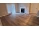 Inviting living room features light-colored wood floors, neutral walls, and a classic white fireplace at 10890 W Evans Ave # 2E, Lakewood, CO 80227