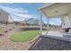 The backyard offers a covered patio, an artificial turf area, and retaining wall at 42338 Forest Oaks Dr, Elizabeth, CO 80107