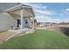 A well-maintained backyard includes a covered patio and an artificial turf area at 42338 Forest Oaks Dr, Elizabeth, CO 80107
