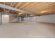 Unfinished basement with exposed wood beams, concrete floor, and utility connections at 42338 Forest Oaks Dr, Elizabeth, CO 80107