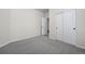 Neutral bedroom with gray carpet, white walls, and closet with white doors at 42338 Forest Oaks Dr, Elizabeth, CO 80107