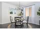 Dining area with a round table, black chairs, and a view of the adjacent window at 42338 Forest Oaks Dr, Elizabeth, CO 80107