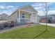 Single-Gathering home showcasing a two-car garage, a covered porch, and manicured lawn at 42338 Forest Oaks Dr, Elizabeth, CO 80107
