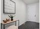 Modern foyer features tile flooring, a console table with decor, and a white front door at 42338 Forest Oaks Dr, Elizabeth, CO 80107