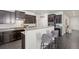 Modern kitchen with stainless steel appliances, granite countertops, dark cabinets, and breakfast bar at 42338 Forest Oaks Dr, Elizabeth, CO 80107