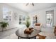 Living room with lots of natural light, a cozy chair, and a sliding glass door to the backyard at 42338 Forest Oaks Dr, Elizabeth, CO 80107