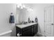 Bathroom with double sink vanity, granite countertop, and a large mirror at 4680 Copeland Loop # 204, Highlands Ranch, CO 80126