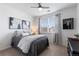 Bedroom with natural light from window, ceiling fan, gray walls, and stylish comforter and decor at 4680 Copeland Loop # 204, Highlands Ranch, CO 80126