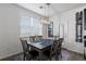 Bright dining room with a modern chandelier and access to a balcony at 4680 Copeland Loop # 204, Highlands Ranch, CO 80126