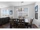 Cozy dining room featuring modern chandelier and dark wood table with seating for six at 4680 Copeland Loop # 204, Highlands Ranch, CO 80126