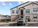 Tan and brown two-story apartment building with parking spot and visitor parking in front at 4680 Copeland Loop # 204, Highlands Ranch, CO 80126