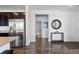 Hallway view of stainless steel refrigerator, bathroom, and decorative table at 4680 Copeland Loop # 204, Highlands Ranch, CO 80126
