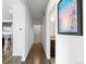 Hallway leading to a bathroom and kitchen with modern stainless steel appliances at 4680 Copeland Loop # 204, Highlands Ranch, CO 80126