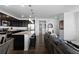 Modern kitchen featuring dark cabinets, stainless steel appliances, and a large island with granite countertops at 4680 Copeland Loop # 204, Highlands Ranch, CO 80126