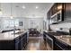 Modern kitchen with stainless steel appliances and a large island, seamlessly flowing into the dining area at 4680 Copeland Loop # 204, Highlands Ranch, CO 80126