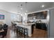 Modern kitchen features a granite island, stainless steel appliances, and dark cabinetry with pendant lighting at 4680 Copeland Loop # 204, Highlands Ranch, CO 80126