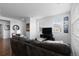 Comfortable living room with large windows, a plush sofa, and entertainment center at 4680 Copeland Loop # 204, Highlands Ranch, CO 80126
