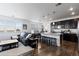 Bright, open-concept living room and kitchen with hardwood floors, granite countertops, and stainless steel appliances at 4680 Copeland Loop # 204, Highlands Ranch, CO 80126