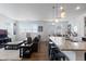 Bright living room with large windows, a comfortable sofa, and open access to the kitchen area at 4680 Copeland Loop # 204, Highlands Ranch, CO 80126