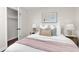 Inviting bedroom featuring a plush bed, elegant artwork, and coordinated decorative pillows at 2405 W 39Th Ave, Denver, CO 80211