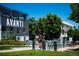 Modern building exterior with Avanti signage, lush greenery, and a bike-sharing station in front at 2405 W 39Th Ave, Denver, CO 80211