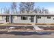 Charming multi-unit gray brick building with neat landscaping and walkway to the front doors at 2405 W 39Th Ave, Denver, CO 80211