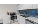 Modern kitchen featuring white cabinets and stainless steel appliances at 2405 W 39Th Ave, Denver, CO 80211