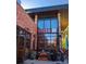 Exterior shot of Bacon Social House featuring red brick, large windows, and outdoor seating at 2405 W 39Th Ave, Denver, CO 80211