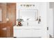 Bathroom with terracotta tile, white vanity, and gold fixtures at 42 Princeton Cir, Longmont, CO 80503