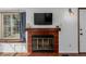 Living room with brick fireplace featuring decorative mantel, and bright window at 11560 Otis St, Westminster, CO 80020