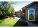 Backyard features a manicured lawn, a patio, and log home at 2965 Wagner St, Strasburg, CO 80136