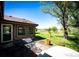 A sprawling backyard with mature landscaping, a stone patio, and open green space at 2965 Wagner St, Strasburg, CO 80136