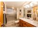 Bright bathroom features a vanity with marble top and a glass-enclosed shower at 2965 Wagner St, Strasburg, CO 80136