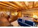 Log-walled bedroom with dresser and quilt-covered bed at 2965 Wagner St, Strasburg, CO 80136