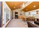 Dining room area with wood paneling, windows and view to other rooms at 2965 Wagner St, Strasburg, CO 80136