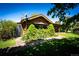 Charming log home with well-manicured landscaping and brick walkway, creating a welcoming entrance at 2965 Wagner St, Strasburg, CO 80136