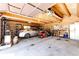 Spacious garage with log beam construction offering parking space and storage for tools and equipment at 2965 Wagner St, Strasburg, CO 80136