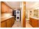 Convenient laundry area boasts cabinetry, sink, washer, dryer, and access to the adjacent bathroom at 2965 Wagner St, Strasburg, CO 80136