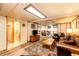 Inviting living room featuring recessed lights, wood floors, and access to a full bathroom at 2965 Wagner St, Strasburg, CO 80136