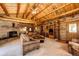 Cozy living room with log walls and a stone fireplace at 2965 Wagner St, Strasburg, CO 80136