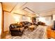 Basement living room featuring wood-look flooring, leather seating, and recessed lighting creates a comfortable, inviting space at 2965 Wagner St, Strasburg, CO 80136