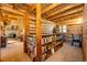 Log cabin living space featuring built-in bookshelves and an open layout leading to a living room with a cozy fireplace at 2965 Wagner St, Strasburg, CO 80136
