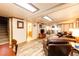 Cozy living room with wood flooring, comfortable leather seating, and adjacent bathroom at 2965 Wagner St, Strasburg, CO 80136