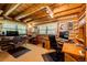 Inviting log cabin home office featuring a wooden ceiling, two windows, and workspace for two, promoting a productive atmosphere at 2965 Wagner St, Strasburg, CO 80136