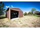 Open storage shed with vehicle and room for storage on a well-maintained lawn at 2965 Wagner St, Strasburg, CO 80136