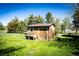 Charming shed with a flower box, located in the verdant backyard at 2965 Wagner St, Strasburg, CO 80136