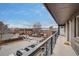 Apartment balcony overlooking the parking lot and neighborhood with a clear blue sky at 120 S Pennsylvania St # 302, Denver, CO 80209